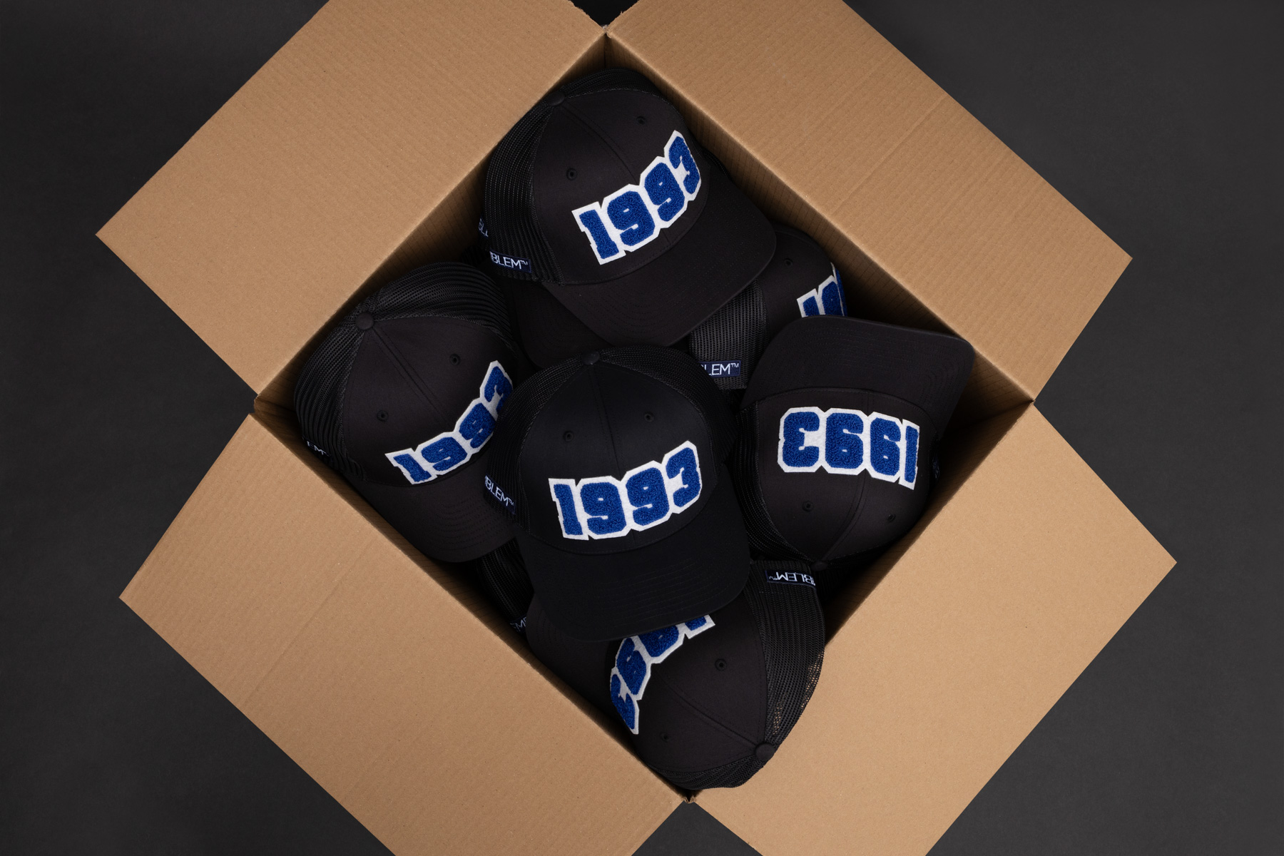 box of hats with chenille patches
