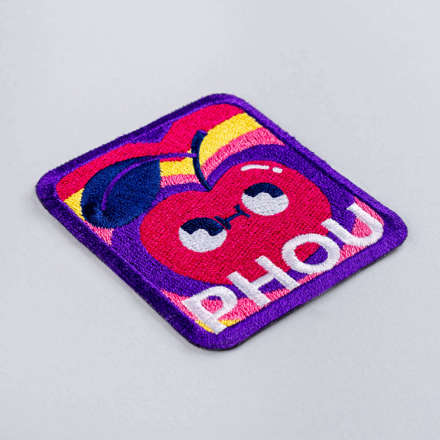 Embroidered PHOU cherry patch laid at a hard angle